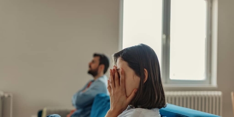 a worried woman with her head in her hands